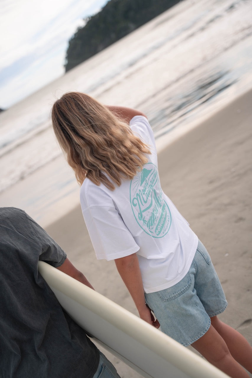 Woman wearing Mount Retro Sea Foam surf shirt at the beach.