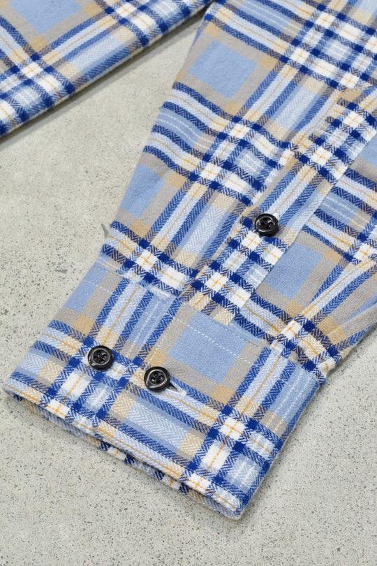Blue plaid flannel shirt with buttoned cuffs, collared neckline, and embroidered details.