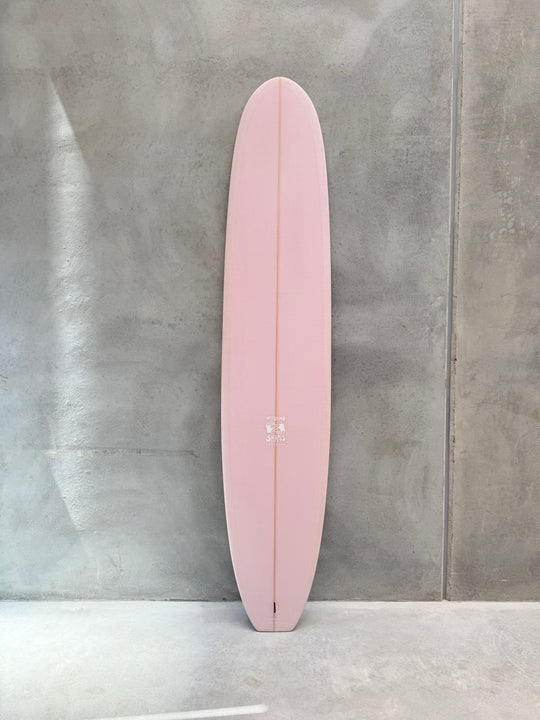 9'4" Electric Lady Longboard with dusky pink tint deck against a gray background.