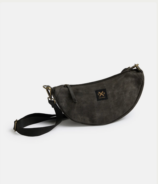 Black waxed canvas Slow Road Shoulder Bag with adjustable strap, round design, and durable build.